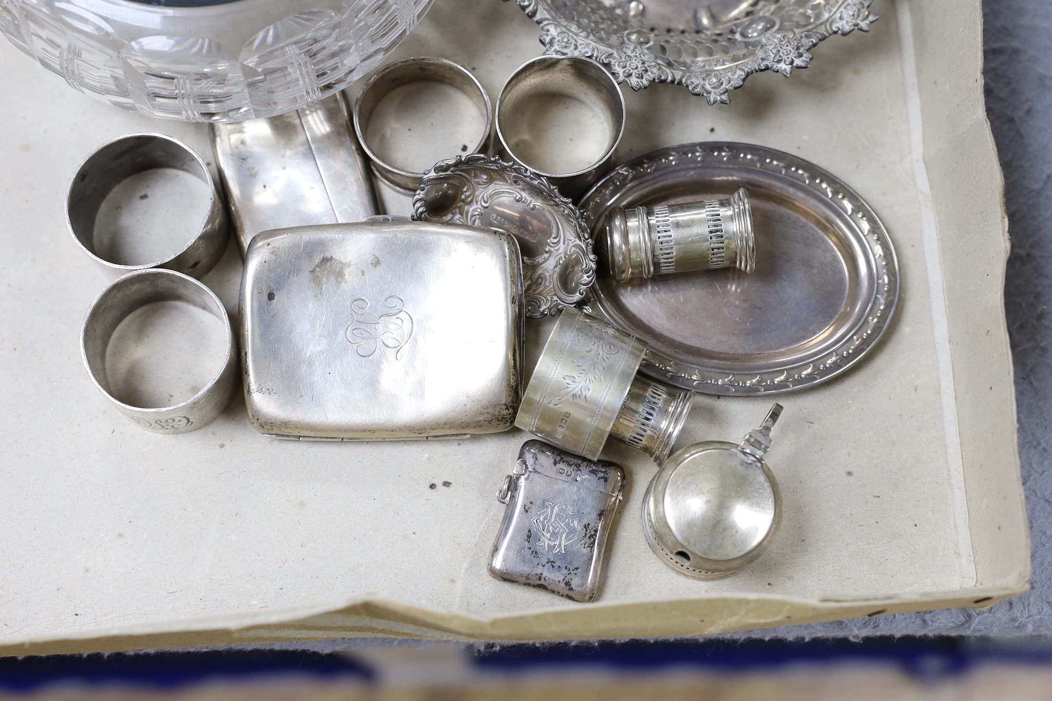 A George V silver mounted glass bowl and cover and other sundry silver including napkin rings, vesta case and condiments.